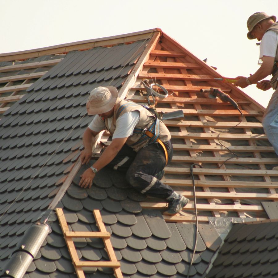 Roofing crew installing shingles